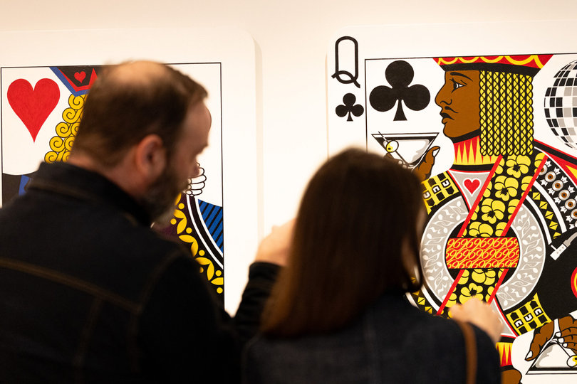 Everson Museum of Art attendees view artist Rich Harrington’s “Queen of Jacks” display. Harrington, a 1980 SU graduate, gave a tour of his exhibition “Rich Harrington: Fissure” on Sept. 19.