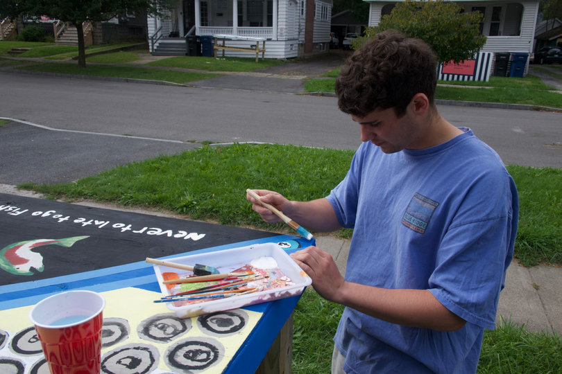 Logan Armistead admires the beer pong table he and his roommates built. Armistead picked the Grateful Dead's bears and a fish design to appear on the table.