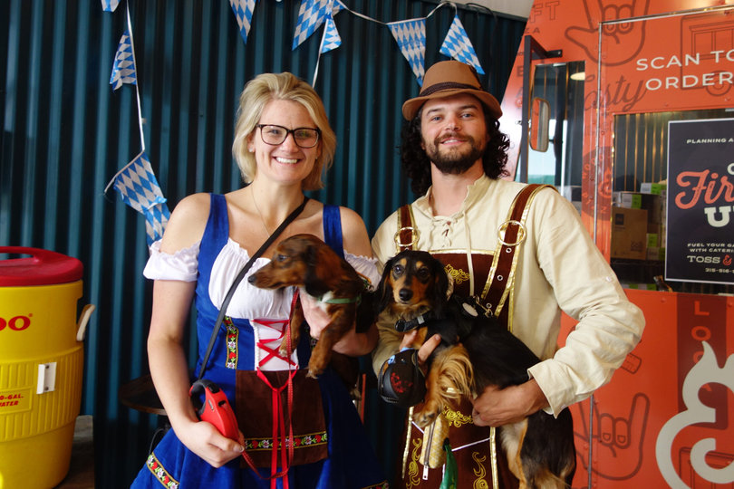 Dressed in Oktoberfest-themed outfits, Shannon Aylesworth and a fellow Harvey’s Garden attendee smile with their dachshunds. Harvey’s fourth annual dachshund race was the finale to Saturday’s Oktoberfest celebration.