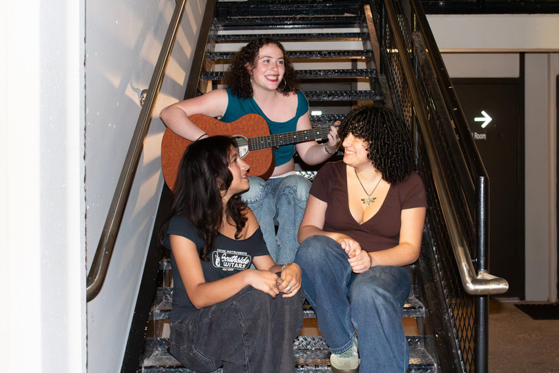 Mothers and Mirrors members Alyssa Pena, Kyra Rubenstein and Ronnie Kabbash sing an acoustic song in a South Campus stairwell. The three met during their freshman year and bonded over their shared passion for music.